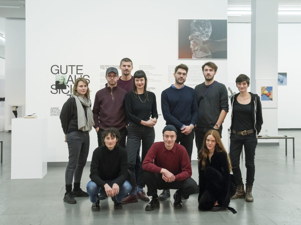 Die Künstlerinnen und Künstler der Ausstellung gute Aussichten posieren für ein Gruppenfoto in den Ausstellungsräumen